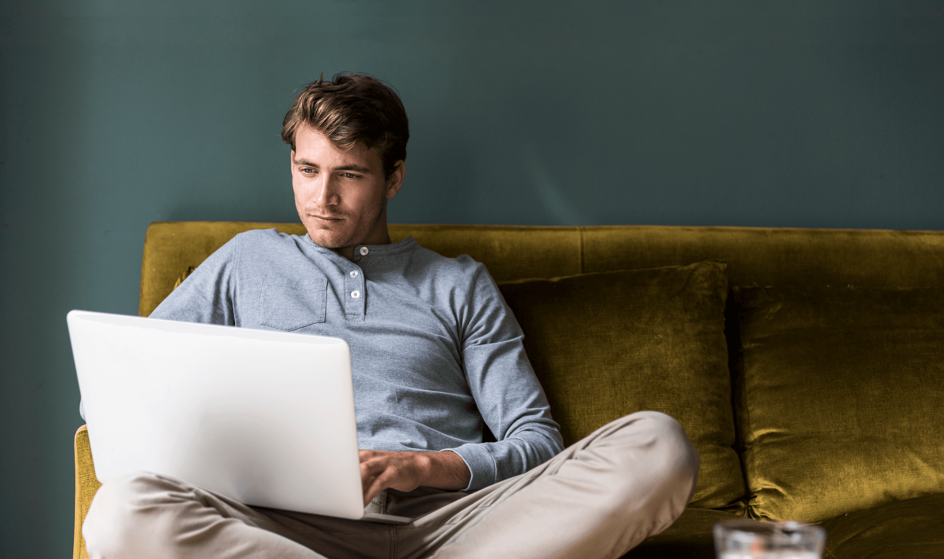 Person is using a laptop on a couch